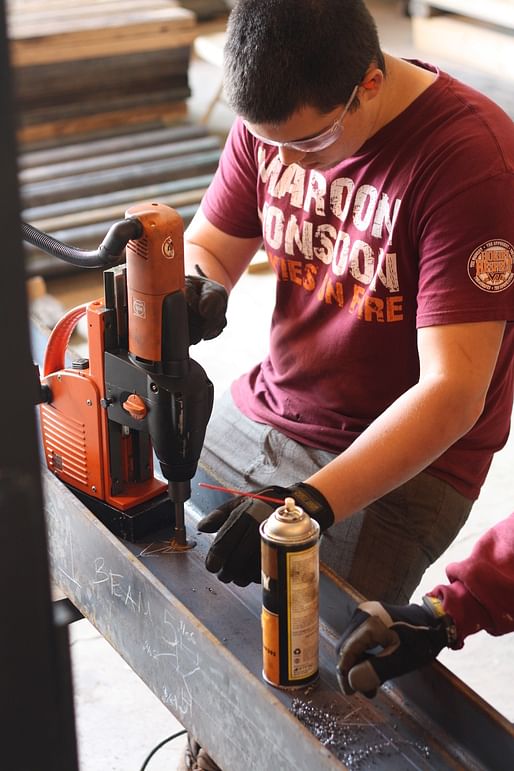 in Blacksburg, everyone was hard at work ms with a mag drill and planing wood for thdrilling holes in the steel beae handrails and guardrails via design/buildLAB