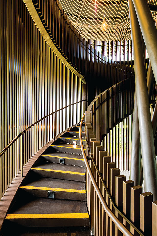 Vertical aluminium trellis filters daylight and views into the staircase and inner spaces