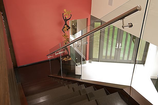 Brushed stainless steel handrail mounted directly onto glass panels