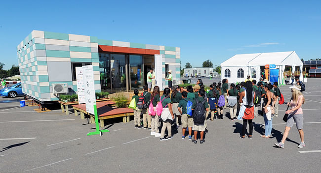 Sixth-grade students from the Watts Learning Center in Los Angeles line up to tour Crowder College and Drury University during the U.S. Department of Energy Solar Decathlon at the Orange County Great Park, Irvine, California, Friday, Oct. 9, 2015. (Credit: Thomas Kelsey/U.S. Department of Energy Solar Decathlon)