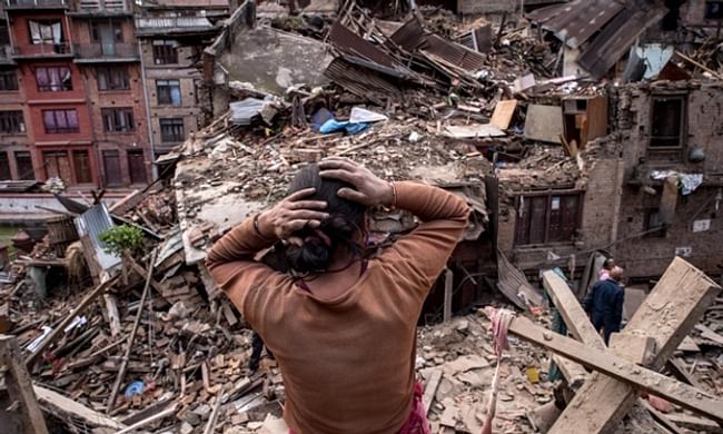 A resident surveys the result of a 7.8 magnitude earthquake in Nepal (courtesy David Ramos/Getty Images).
