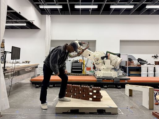 Artist, architect, and Tuskegee alumnus Myles B. Sampson tests a robotic stacking method for his sculpture Brick Parable, 2024. Image courtesy Helen B. Bechtel