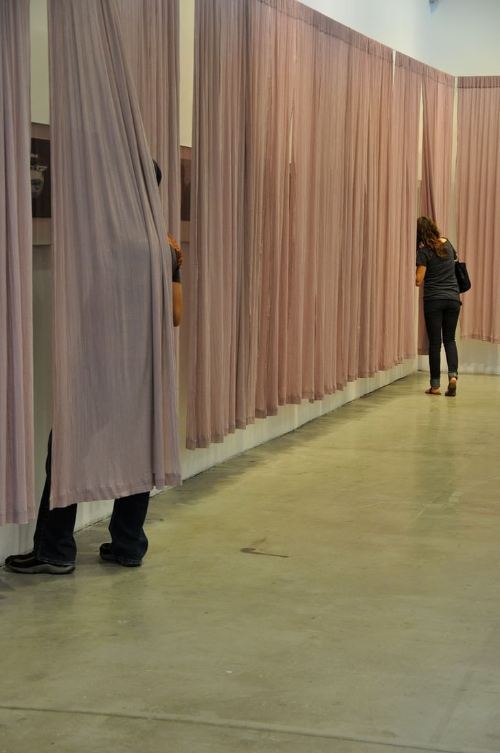 Viewers inspecting Howard's Villa renderings, at the 'From Furniture to Architecture, From Hand to Mouse' exhibition at SCI-Arc Gallery, November 2010. Courtesy of Coy Howard.