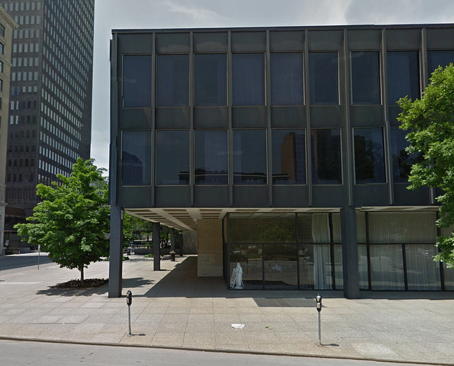 Another view of the Catholic Pastoral Center, with a white statue framed in the window. Image via Google Maps.
