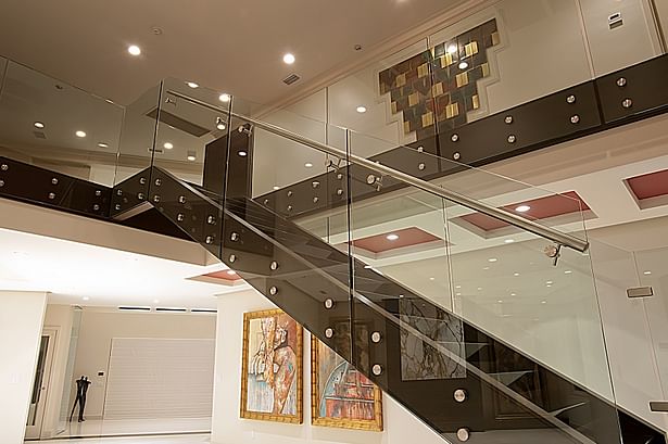 Glass railings & brushed stainless steel elements transformed this residential home.