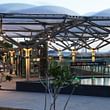 The canopy and reflective pool help integrate the Marina Bay Station into the park environment.
