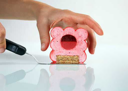 Raspberry cake made to look like red bubbles encased in a cube by Dinara Kasko. Image: Dinara Kasko. 