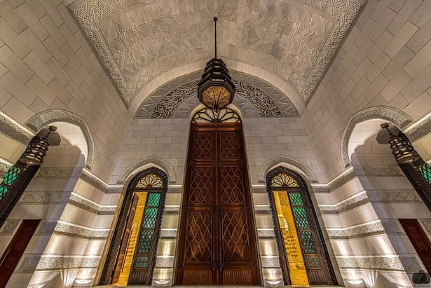 Grand Entrance to the Main Prayer Halls. 10m high Timber door at the centre and 4 cast bronze doors with decorative coloured glasses on sides.