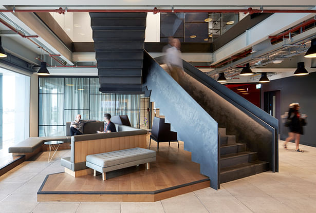 The stairs also act as partial enclosures for informal meeting areas