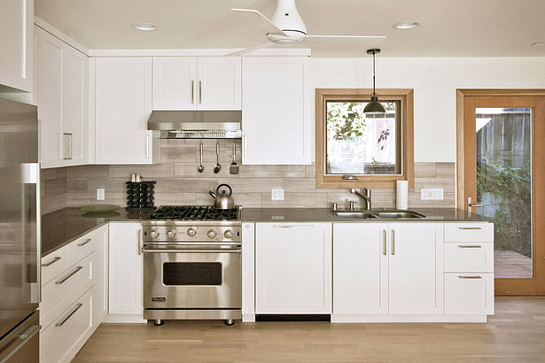 contemporary custom kitchen with quartz counters, limestone backsplash + shaker details