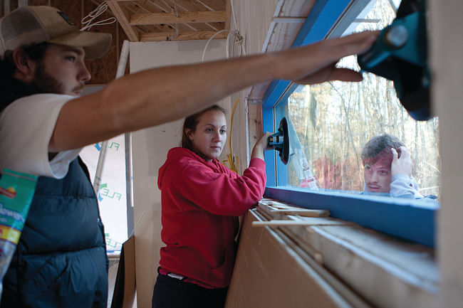Students installing custom-made windows