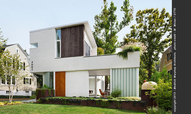 The street view of the house shows how the landscape seems to flow over and through the house.