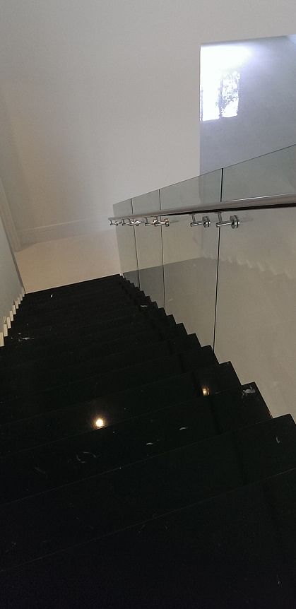 Stainless steel handrail mounted directly onto glass panels