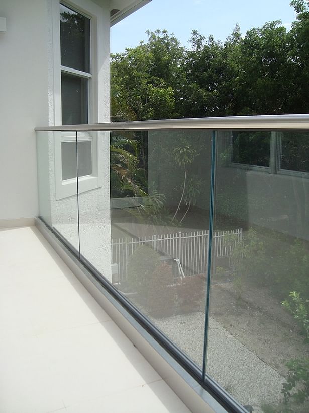 Base Shoe with Stainless Steel Cladding, Laminated Glass Railings, and a Stainless Steel Cap Rail.
