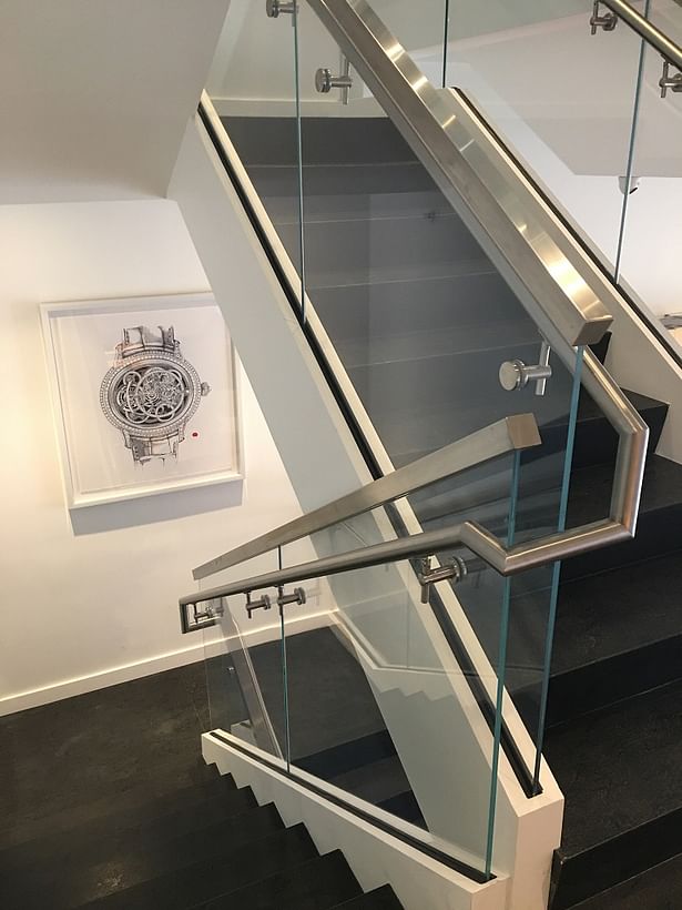 Squared Stainless Steel Cap Rails were Top Mounted to each Glass Panel