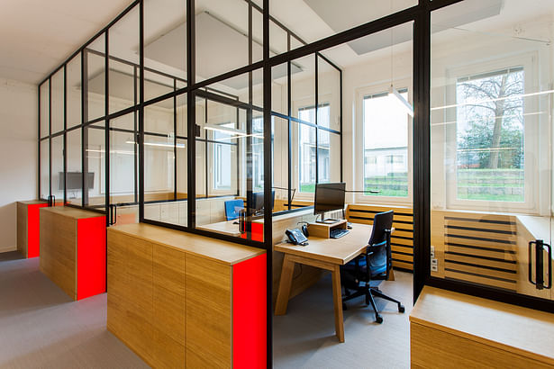 in the rear part of the office, glass partitions create private offices