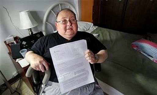 Disabled resident of Harbor Manor Robert Rosenberg displays a letter sent to him by FEMA asking for repayment for disaster aid. Credit: AP / Kathy Willens