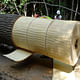 The tree was harvested and de-barked in late spring, when its sap was so wet that the bark, once scored, slides off like a peel. The bark was cut, stacked, and air-dried to make the shingles that now cover the concession stand kiosk. Courtesy Visiondivision.