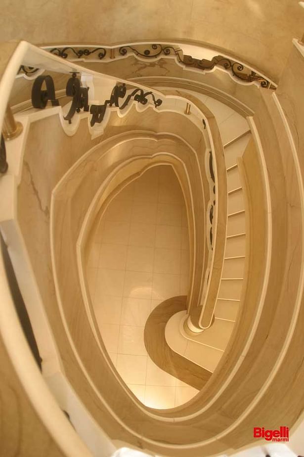 Helical staircase in Pietra Dorata honed and Bianco Thassos polished.