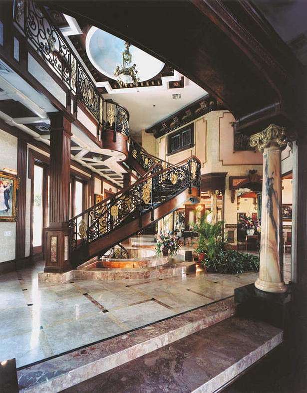 Foyer illustrating eclectic elements. Imported marble columns from China, marble floors, wood and synthetic moldings