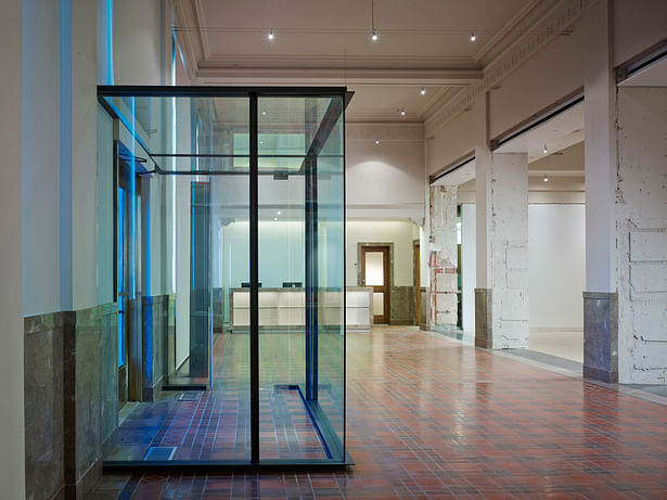 The original drawings showed a vestibule in the building. It was never built. The new glass and steel vestibule clearly states a 21st Century change.