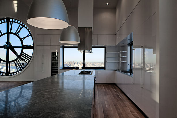 GLAM Kitchen - the cabinetry edges, as well as the refrigerator door, the wine cooler and the upper cabinets are mitered at 45-degree angles with all side panels, creating flat planes and clean lines