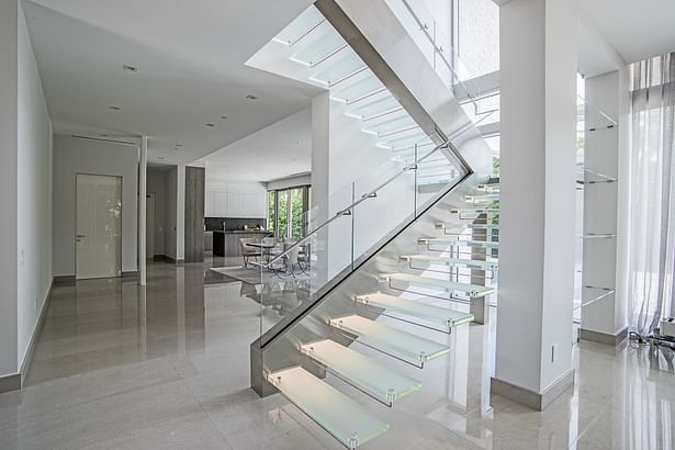 Complementing elements of brushed stainless steel surround the starphire glass railings