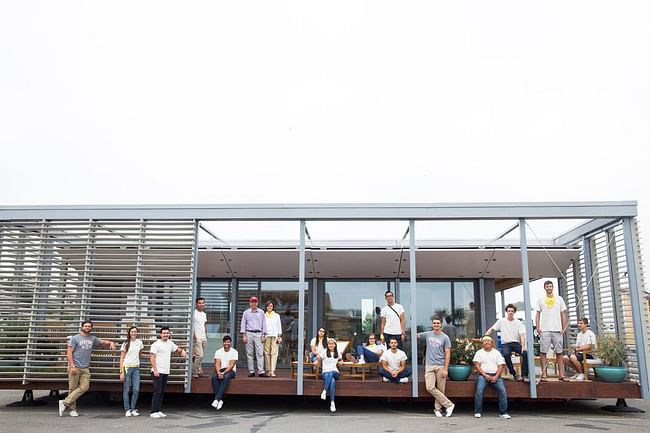 The 2015 Solar Decathlon winning team Stevens Institute of Technology poses with their competition house, the SURE HOUSE. Photo courtesy of Stevens Institute of Technology.