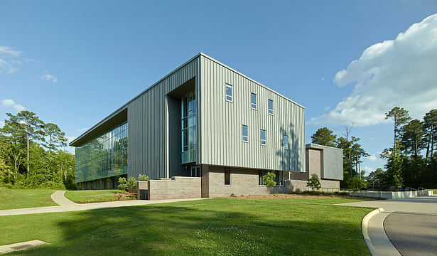 The complex is located is a wooded education and research campus. This is a view from the campus loop road.