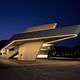 The terminal's exterior at night. Image credit: Helene Binet / courtesy of Zaha Hadid Architects