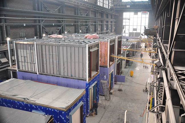 The micro-apartments being assembled before delivery to the construction site, where they are stacked by crane (photo via nARCHITECTS).