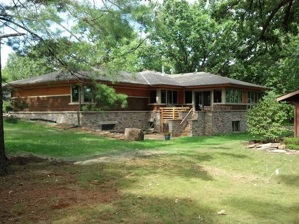 Pulling the house as close to the street corner as setbacks would allow improved views to golf course ski trails and rear south west views. It also created a very usable backyard and patio area to the more private, sunny, and wind sheltered, south side of the house.