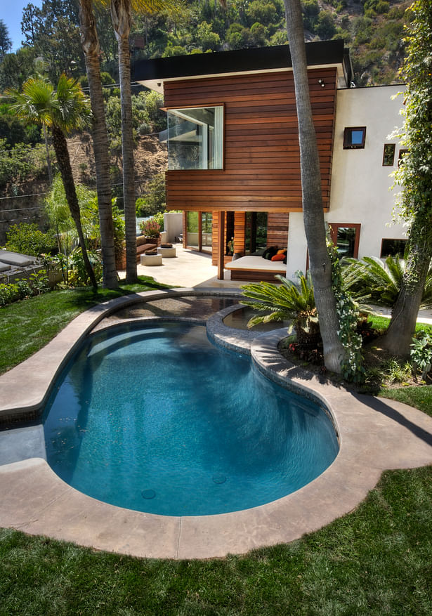 Now shallower, the existing kidney shaped pool was redesigned to incorporate a jacuzzi and a 3” deep wading pool for “floating” lounge furniture. 