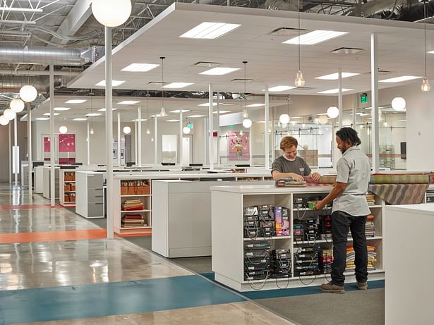 Custom designed work islands located throughout the space provide a perfect mix of storage and collaborative space. In addition, the islands house hidden printing stations to help keep the space clutter free.