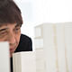 Photo of Tadao Ando examining a model of 152 Elizabeth Street