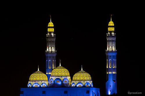 Night view of illuminated gold mosaic cladded domes.