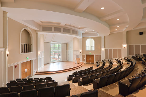 The building configuration allowed for introduction of natural light on three sides of the tiered auditorium. As in the opposite wing, painted millwork using classical detailing defines the space.