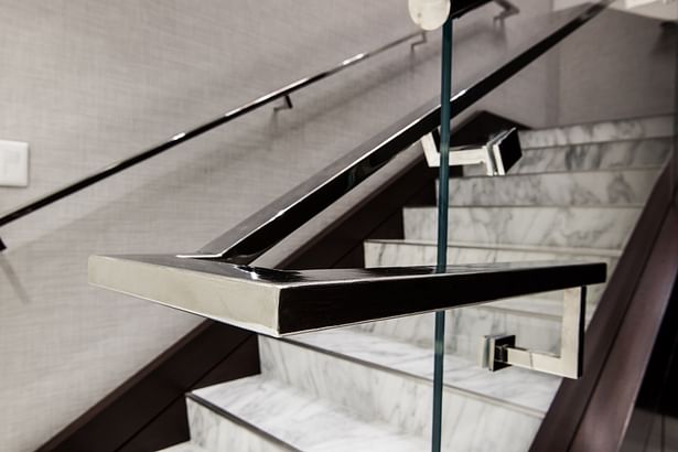 Flat bar handrail mounted directly onto glass panels.
