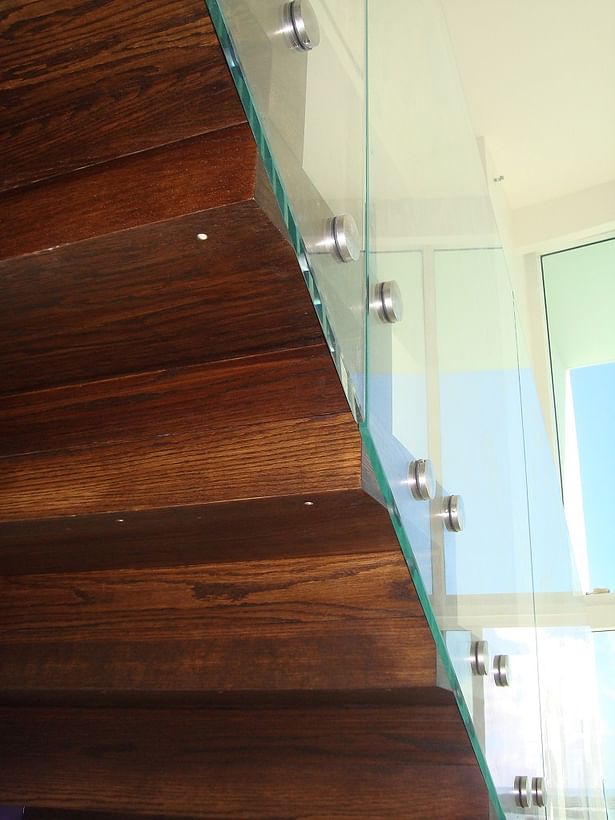 Glass railings & brushed stainless steel elements transformed this residential home.