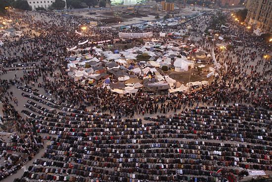 A general view shows Egyptian anti government protesters praying at sunset on Cairo's Tahrir Square, on February 7, 2011, on the 14th days of protests calling for an end to Hosni Mubarak's regime. (MOHAMMED ABED/AFP/Getty Images / Getty)