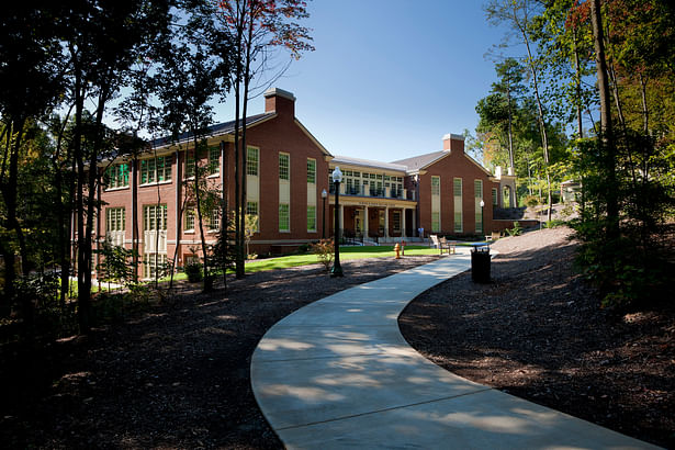 Nestled into a wooded site, the formal front of the Welcome Center faces the main entrance road to the University.