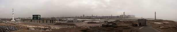 Panorama with the building in the old harbor and the city of Ostend in the distance.