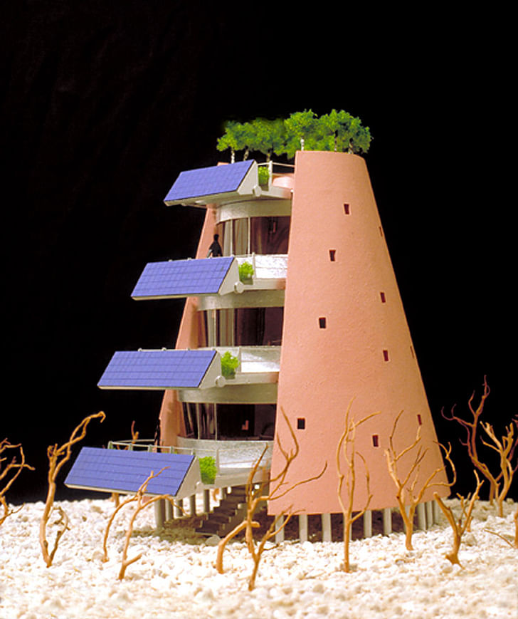 The Solar Electric Desert House designed in 1995: a large adjustable( to accommodate changing sun angles) array of photovoltaic cells are mounted on the front of multi-level exterior deck spaces. The structure also has a group of trees planted around the top deck.