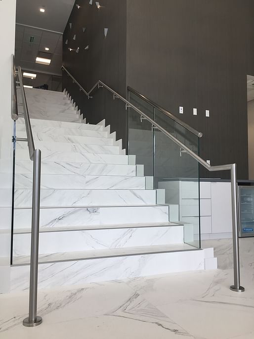 Rounded Stainless Steel Handrails in a Brushed Finish were installed on both sides of this Commercial Staircase, as per Florida Building Code.