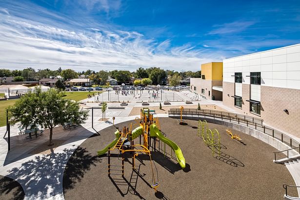 view of playground with sports field beyond