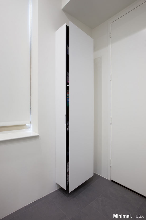 The outstanding wardrobe is made of the same material of the vanity and its mitered edge allows it to close perfectly, turning it into a free standing column yet camouflaged from the sight. 