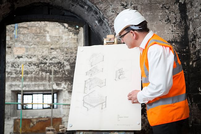 Professor Tom Inns examines plans of the west wing of the Mackintosh Building. Photo: Alan McAteer. 