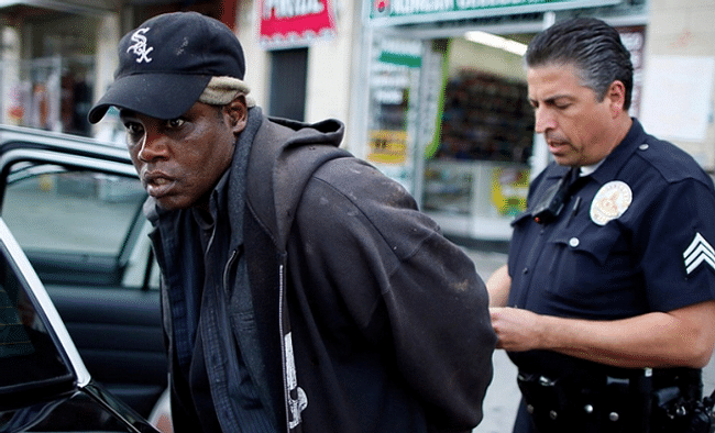 Homeless man arrested in NYC. Credit: Lucy Nicholson / REUTERS / LANDOV