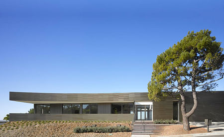 The exterior of the home includes a 9' motorized front door panel. Image courtesy of SPF:architects