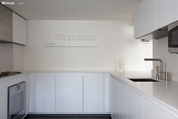 This small kitchen of only 43 square feet, is equipped with every comfort, hidden by white lacquered cabinets. On the left side: fridge, freezer, cooktop and oven all by Gaggenau; on the right side: dishwasher by Miele and microwave by GE.